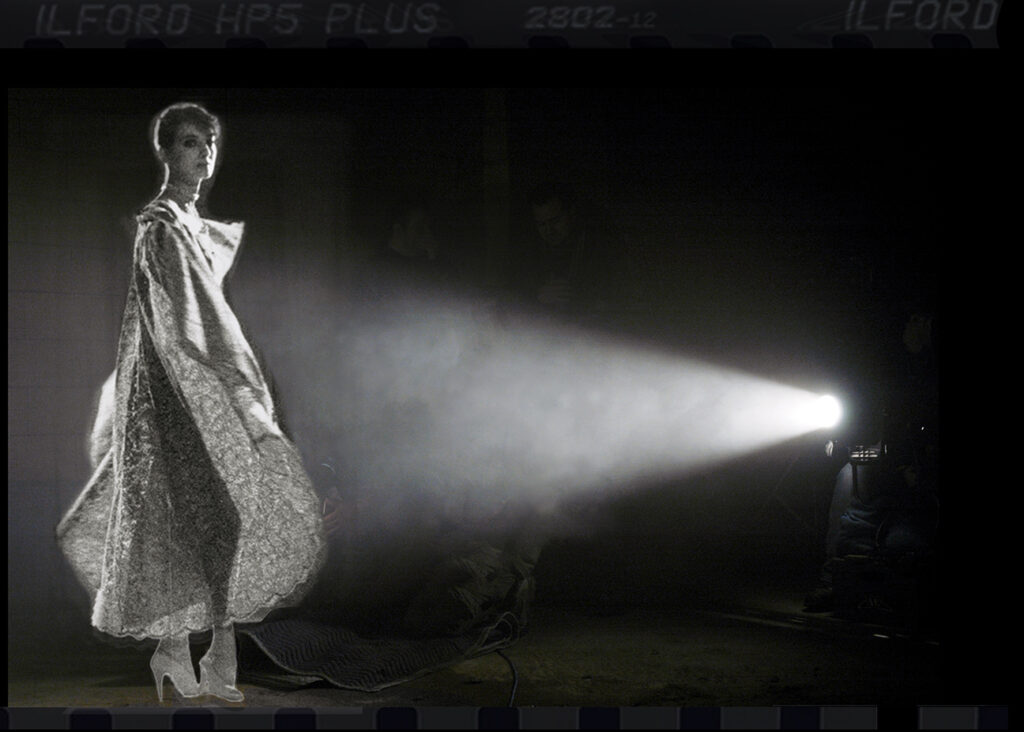 Iconic Toronto model Donna DeMarco wears a striking piece of Gerald Franklin couture fashion, lit by dramatic, cinematic spotlighting. Presented in an avant-garde, high-fashion photo by Daniel Alvarado (1984).